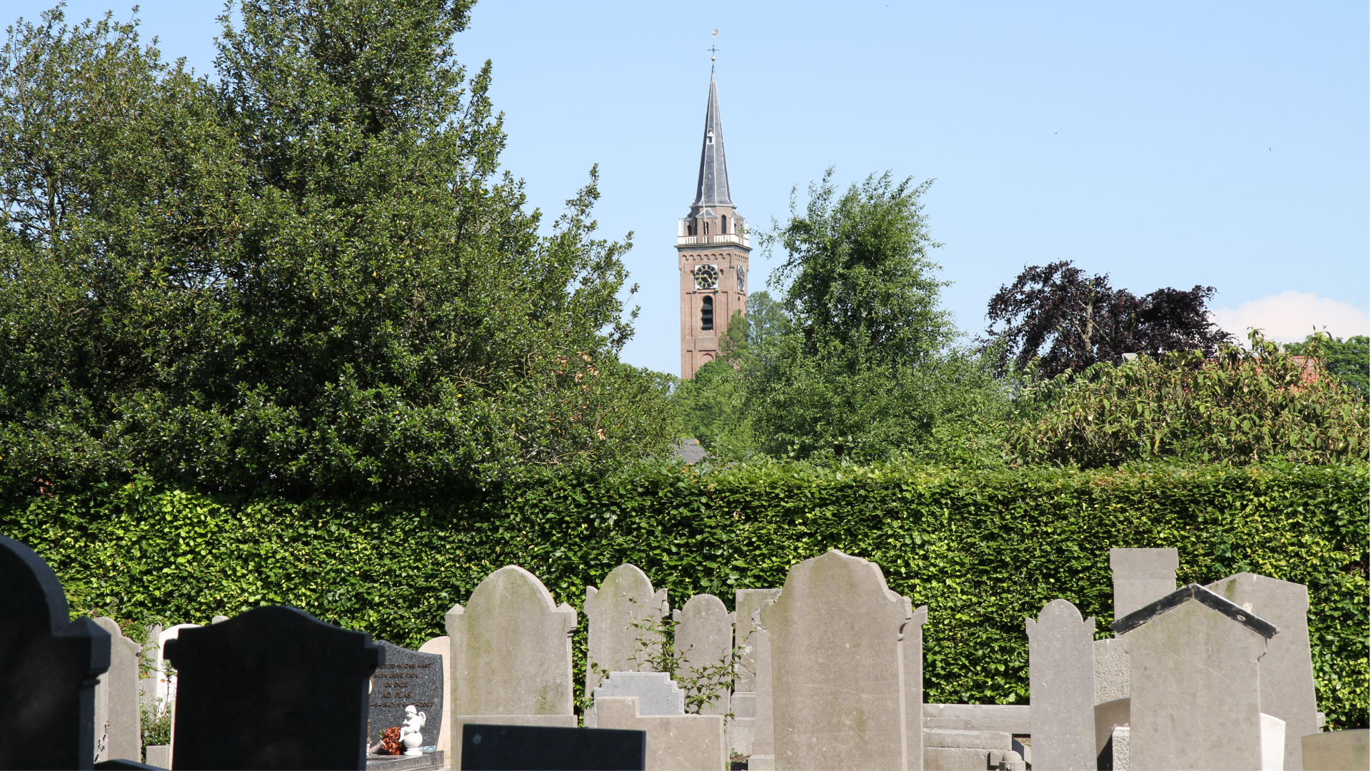 Oude gedeelte begraafplaats met kerk op achtergrond